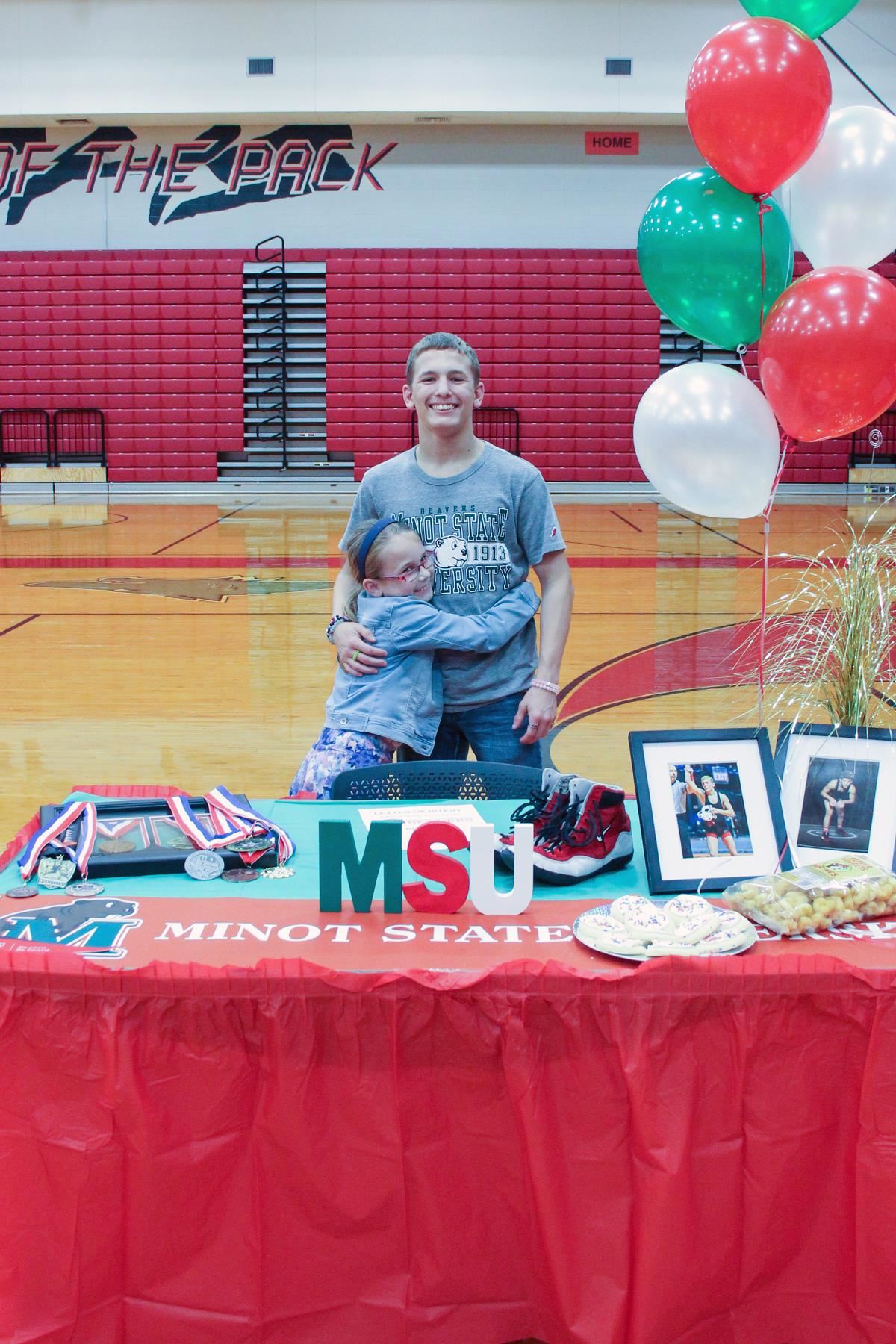 Langham Creek High School senior Caden Lopez, right, signed a letter of intent to Minot State University.